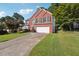 View of the exterior of a brick home with a two car garage, green lawn and driveway at 3272 Monarch Pine Dr, Peachtree Corners, GA 30071