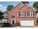 Charming two-story brick home with a well-manicured lawn and attached two car garage at 3272 Monarch Pine Dr, Peachtree Corners, GA 30071