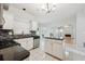 Modern kitchen with stainless steel appliances, a center island, and a view of the living area at 3272 Monarch Pine Dr, Peachtree Corners, GA 30071