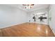 Living room features hardwood floors, ceiling fan, and view of kitchen at 3272 Monarch Pine Dr, Peachtree Corners, GA 30071