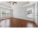 Main bedroom features hardwood floors, ceiling fan, and large windows at 3272 Monarch Pine Dr, Peachtree Corners, GA 30071