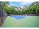 This property includes access to a fenced community tennis court surrounded by trees for a private playing experience at 3272 Monarch Pine Dr, Peachtree Corners, GA 30071