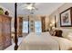 Spacious bedroom featuring a four-poster bed, ceiling fan, and natural light from the windows at 5415 Northland Ne Dr # 303, Atlanta, GA 30342