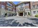 Brick building with stone accents, balconies, and a cobblestone entrance at 5415 Northland Ne Dr # 303, Atlanta, GA 30342