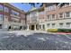 Elegant brick building featuring stone accents, balconies, and a cobblestone drive at 5415 Northland Ne Dr # 303, Atlanta, GA 30342