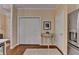 Hallway with hardwood floors, white closets, and view of the kitchen at 5415 Northland Ne Dr # 303, Atlanta, GA 30342