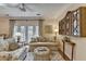 Spacious living room opens to balcony and features ceiling fan and decorator mirror at 5415 Northland Ne Dr # 303, Atlanta, GA 30342