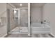 Well-lit bathroom with a glass enclosed shower and a soaking tub at 738 Woodstock Grove Dr, Woodstock, GA 30188