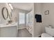 Well-lit bathroom featuring tile flooring and a floral shower curtain at 738 Woodstock Grove Dr, Woodstock, GA 30188