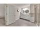 Bathroom featuring double sinks and a glass shower at 738 Woodstock Grove Dr, Woodstock, GA 30188