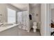 Bright bathroom featuring a floral shower curtain at 738 Woodstock Grove Dr, Woodstock, GA 30188
