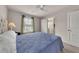 Bright bedroom featuring carpet, a ceiling fan and an adjacent bathroom at 738 Woodstock Grove Dr, Woodstock, GA 30188