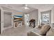 Well-lit bedroom with a ceiling fan and a seating area at 738 Woodstock Grove Dr, Woodstock, GA 30188