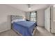 Cozy bedroom featuring carpet, a ceiling fan and a bed with a tufted headboard at 738 Woodstock Grove Dr, Woodstock, GA 30188