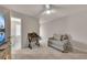 Cozy bedroom with a ceiling fan and a sitting area at 738 Woodstock Grove Dr, Woodstock, GA 30188