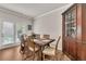 The dining room features hardwood floors, access to the outside and is adjacent to a vintage display cabinet at 738 Woodstock Grove Dr, Woodstock, GA 30188