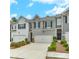 Charming townhome with gray and white siding, a two car garage and great curb appeal at 738 Woodstock Grove Dr, Woodstock, GA 30188