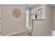 Upstairs hallway featuring neutral paint and carpet with views into adjacent rooms at 738 Woodstock Grove Dr, Woodstock, GA 30188