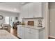 The kitchen features granite countertops, white cabinets, and stainless appliances and opens to the living and dining areas at 738 Woodstock Grove Dr, Woodstock, GA 30188