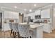 Modern kitchen with granite countertops, stainless steel appliances, and stylish barstool seating at 738 Woodstock Grove Dr, Woodstock, GA 30188