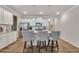 Modern kitchen island with seating, stainless steel appliances, and white cabinetry at 738 Woodstock Grove Dr, Woodstock, GA 30188