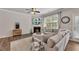 Comfortable living room featuring a fireplace, a ceiling fan and a large window at 738 Woodstock Grove Dr, Woodstock, GA 30188
