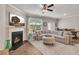 Inviting living room with fireplace, large windows, and plenty of comfortable seating at 738 Woodstock Grove Dr, Woodstock, GA 30188