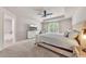 Spacious main bedroom with neutral paint, tray ceilings, ceiling fan, large window, and a walk-in closet at 738 Woodstock Grove Dr, Woodstock, GA 30188