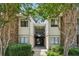 Charming condo exterior with stone accents, balcony, and lush landscaping at 1504 Wingate Way, Atlanta, GA 30350