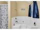 Bright bathroom showcasing a soaking tub with white tile surround, dark blue accents, and natural lighting at 191 Baywood Way, Hiram, GA 30141