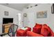 Cozy bedroom/office space featuring red seating, carpet flooring, and a view to the ensuite bathroom at 191 Baywood Way, Hiram, GA 30141