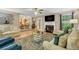 Bright living room with fireplace, hardwood floors, ceiling fan, and open access to the kitchen and dining area at 191 Baywood Way, Hiram, GA 30141