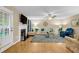 Cozy living room with hardwood floors, a fireplace, and a ceiling fan for added comfort at 191 Baywood Way, Hiram, GA 30141