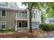 Exterior view of home with upper deck, multiple windows, and beautiful green trees at 1910 Countryside Se Pl, Smyrna, GA 30080