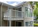 Exterior view of home with upper deck, multiple windows, and beautiful blue sky at 1910 Countryside Se Pl, Smyrna, GA 30080