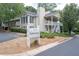 Exterior of a two-story home with off white siding, a chimney, landscaping, and mailboxes out front at 1910 Countryside Se Pl, Smyrna, GA 30080