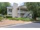 Exterior view of a two-story home with white siding and a stairway to the second level at 1910 Countryside Se Pl, Smyrna, GA 30080
