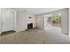 Living room with neutral walls, carpet, fireplace, and a large sunny window at 1910 Countryside Se Pl, Smyrna, GA 30080