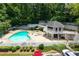 Aerial view of the community pool with a sundeck and chairs. Lush green trees surround the pool at 1910 Countryside Se Pl, Smyrna, GA 30080