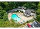 Aerial view of a community pool with ample seating and a covered clubhouse at 1910 Countryside Se Pl, Smyrna, GA 30080