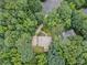 Aerial view of the home nestled amongst mature trees, showcasing its secluded location and neighborhood at 217 Bridgewater Trl, Canton, GA 30115
