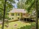 Backyard view with lawn, mature trees and an elevated wooden deck attached to the house at 217 Bridgewater Trl, Canton, GA 30115