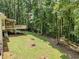Expansive backyard with lawn and trees, featuring a screened porch and deck at 217 Bridgewater Trl, Canton, GA 30115