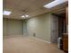 Unfinished basement with neutral carpet and lighting at 217 Bridgewater Trl, Canton, GA 30115