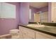 Bathroom with shower, toilet, and vanity with white cabinets and green counter at 217 Bridgewater Trl, Canton, GA 30115
