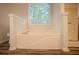 Bright bathroom featuring soaking tub with tiled backsplash and private shower at 217 Bridgewater Trl, Canton, GA 30115