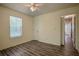 Empty bedroom with a window, closet, and door leading to the hallway at 217 Bridgewater Trl, Canton, GA 30115