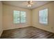 Bright bedroom featuring stylish wood-look flooring and a ceiling fan at 217 Bridgewater Trl, Canton, GA 30115
