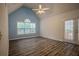 Bedroom with vaulted ceilings, natural light from the window, and access to a private balcony at 217 Bridgewater Trl, Canton, GA 30115