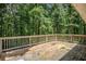 A wooden deck with white railings offers space overlooking a private, wooded yard at 217 Bridgewater Trl, Canton, GA 30115